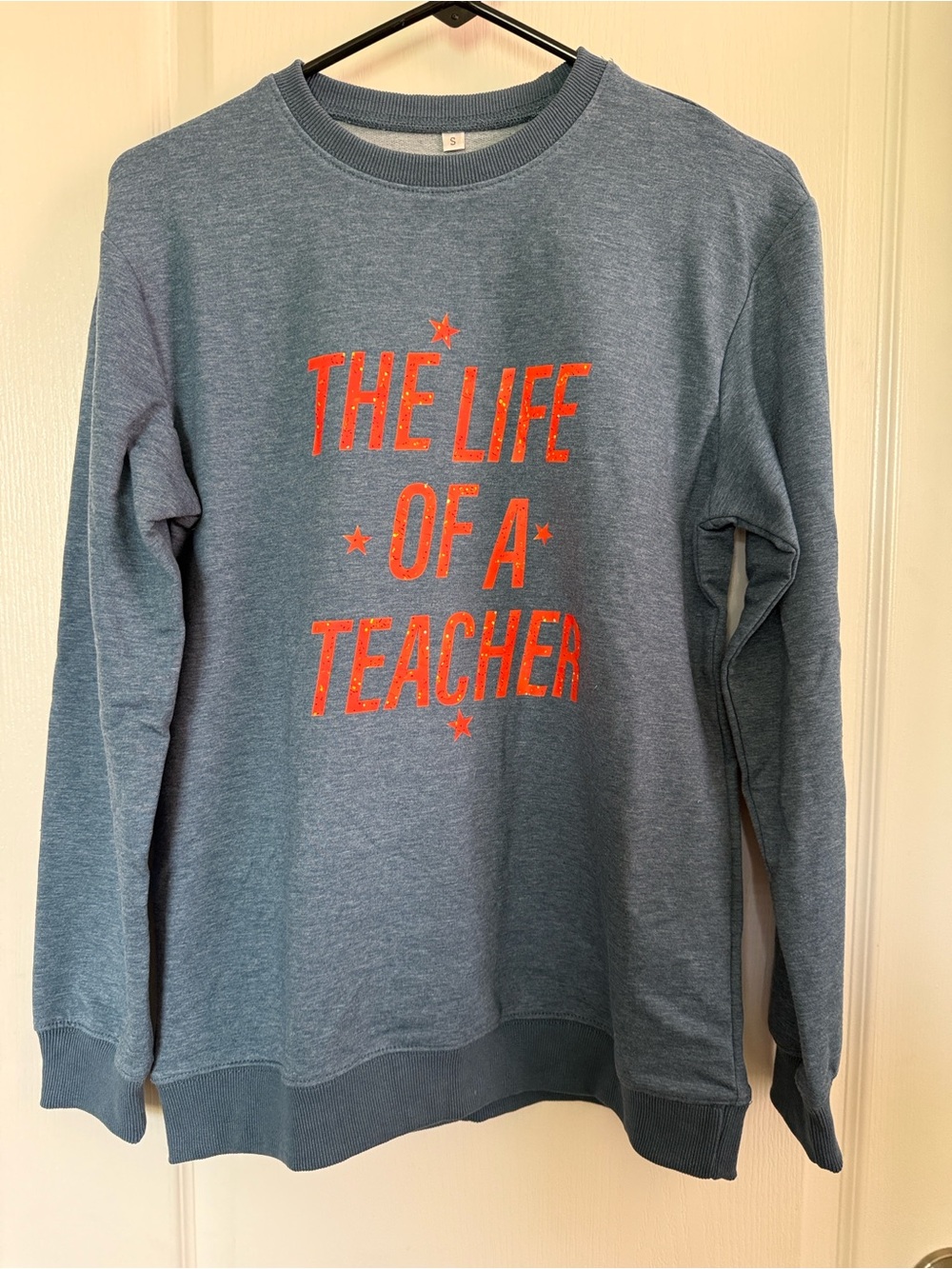 Women’s Crewneck Sweatshirt in Heather Blue with Orange Text